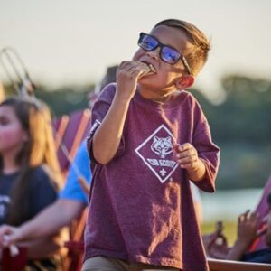 Cub-Scout-boy-eating-smore-girls-in-background-650px-e1622740963284 Cub-Scout-boy-eating-smore-girls-in-background-650px-e1622740963284